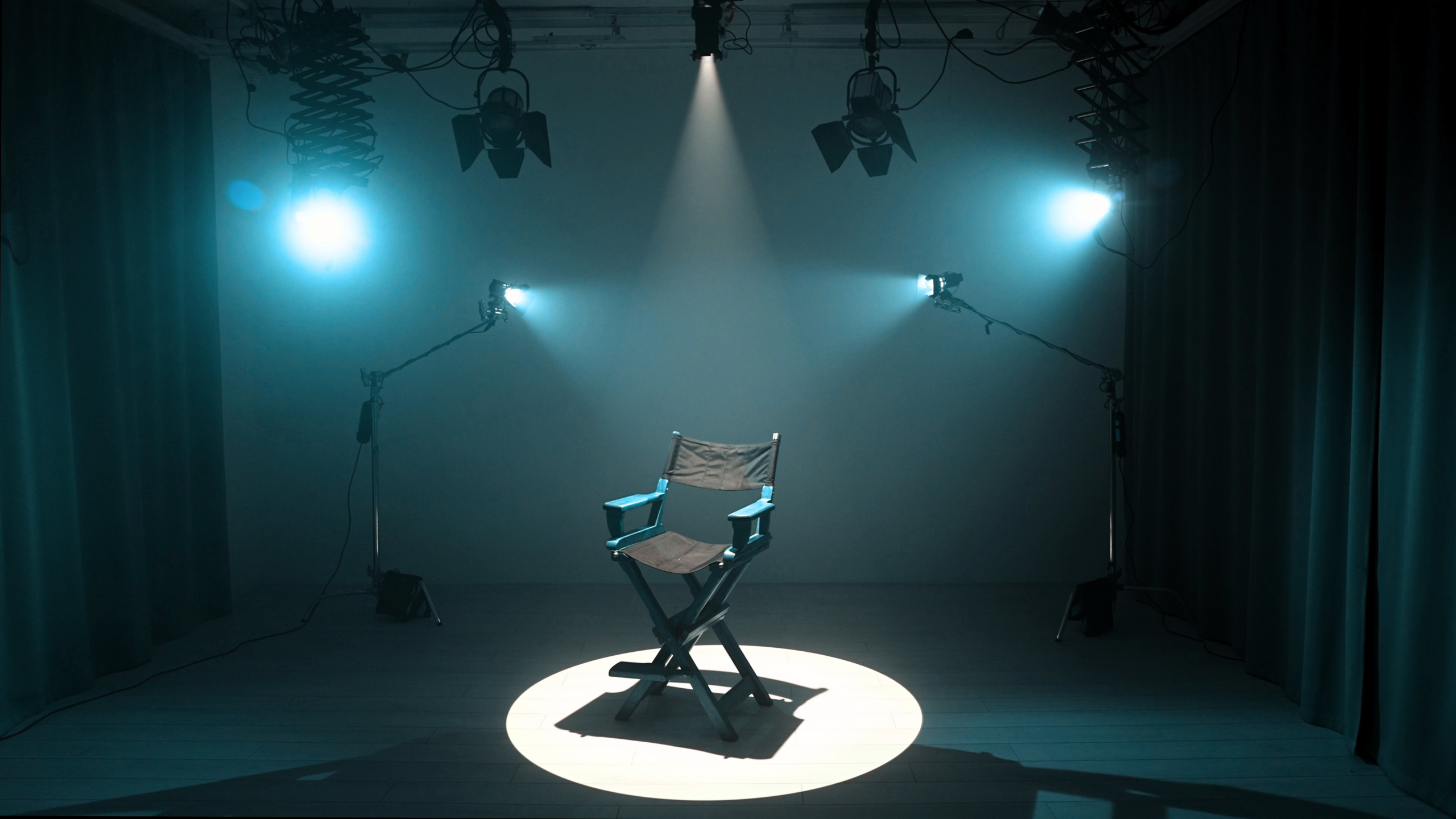 A chair in a blue room with a spotlight for the article, ASPPB’s Pathways to Servant Leadership Saluting the Volunteers, Jurisdictional Board Members Supporting Our Success.