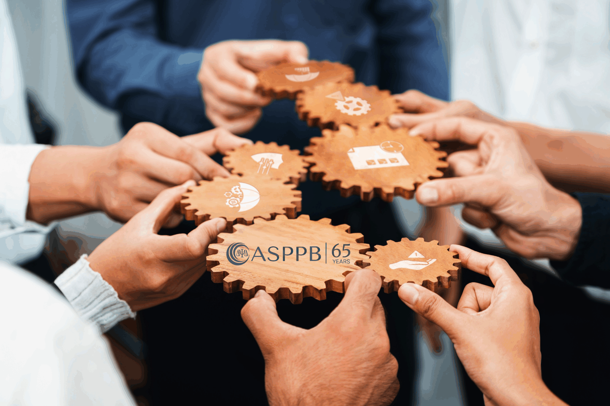 A 65-Year Commitment to Consistent, High-Quality Licensing Standards. Image of people holding gears with professional licensure symbols. The center symbol has the logo for ASPPB's 65th anniversary.